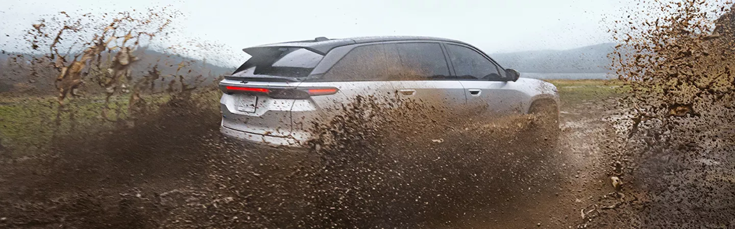 2025 Jeep Wagoneer driving through the mud in the countryside