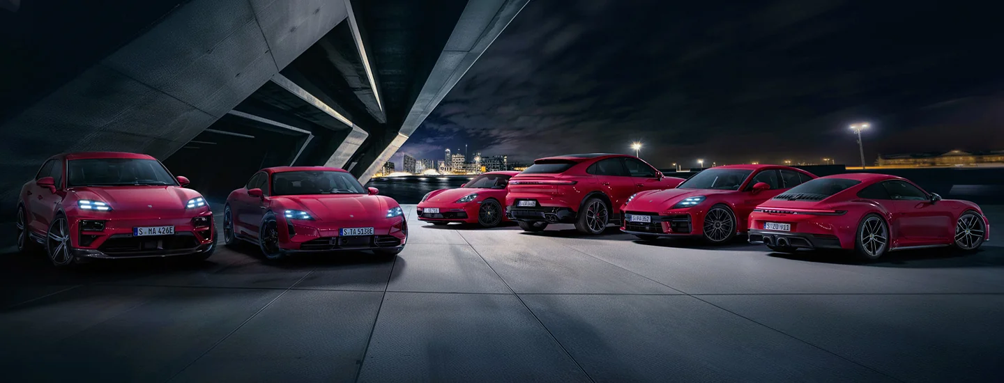 many red Porsche lined up park in rows