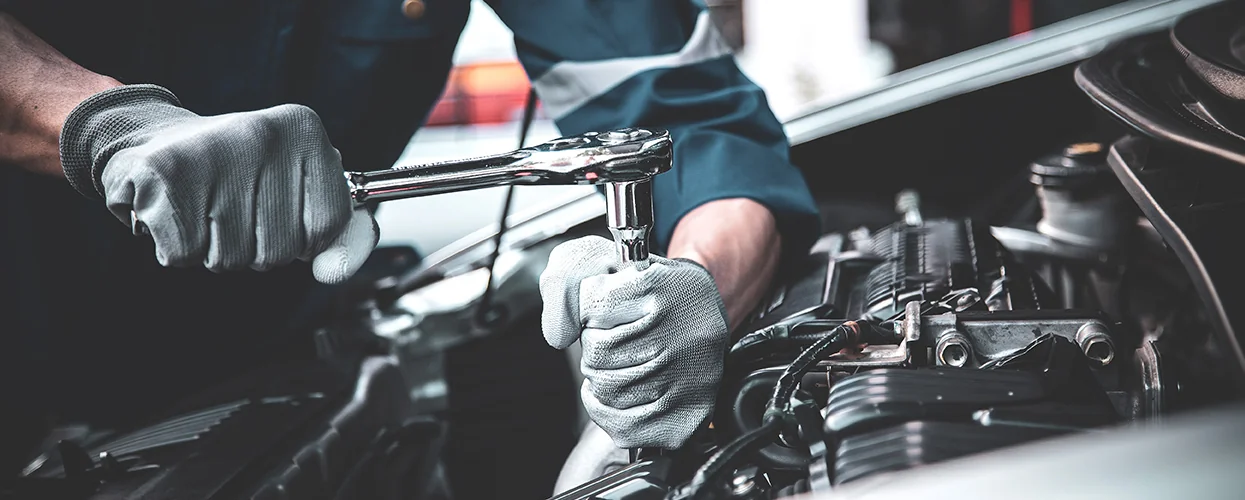 Service tech working on a engine service