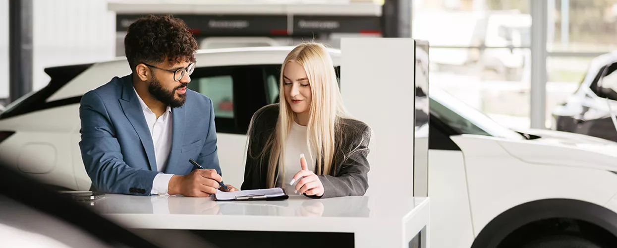 Car salesman and customer talking about a contract