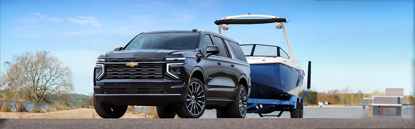 2025 Chevrolet Suburban pulling a boat out of the water