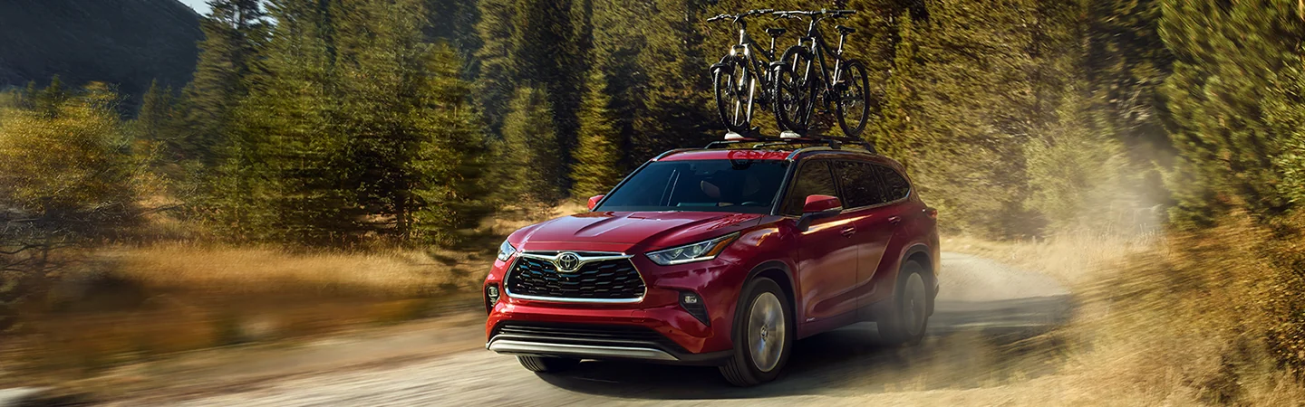2025 Toyota Highlander driving down a dirt road