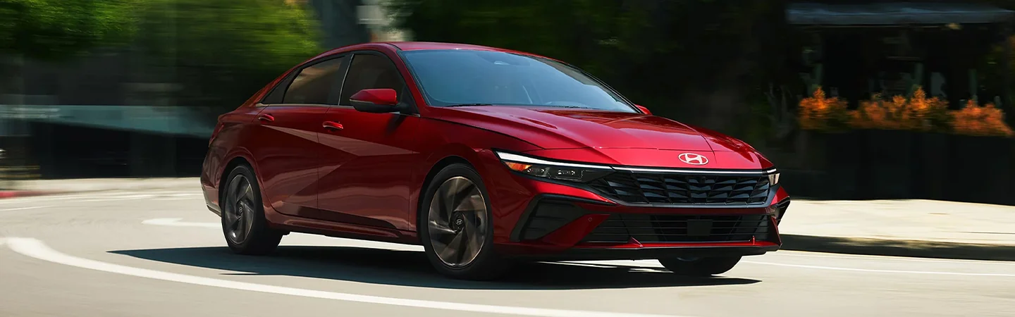 2024 Hyundai Elantra vs Toyota Camry front view red 