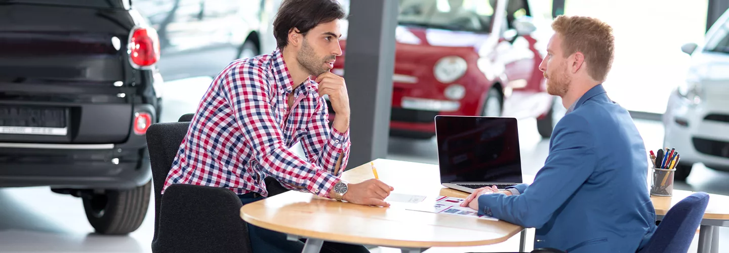Car salesman talking to a customer