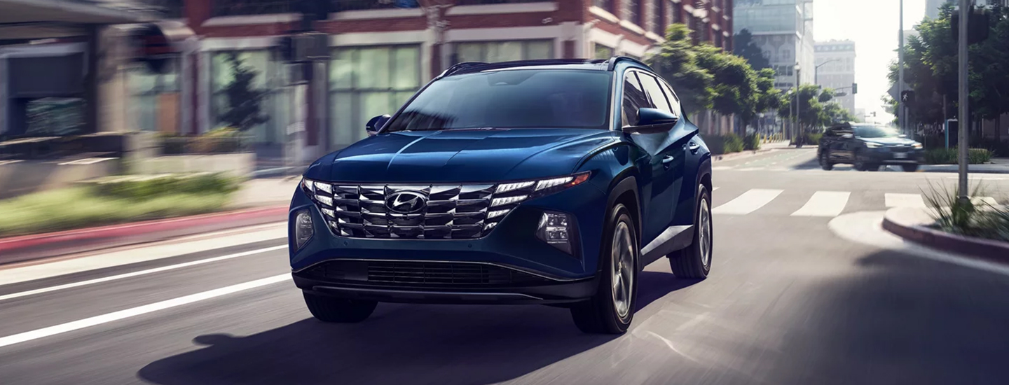 2024 Hyundai Tucson Hybrid Blue driving in city