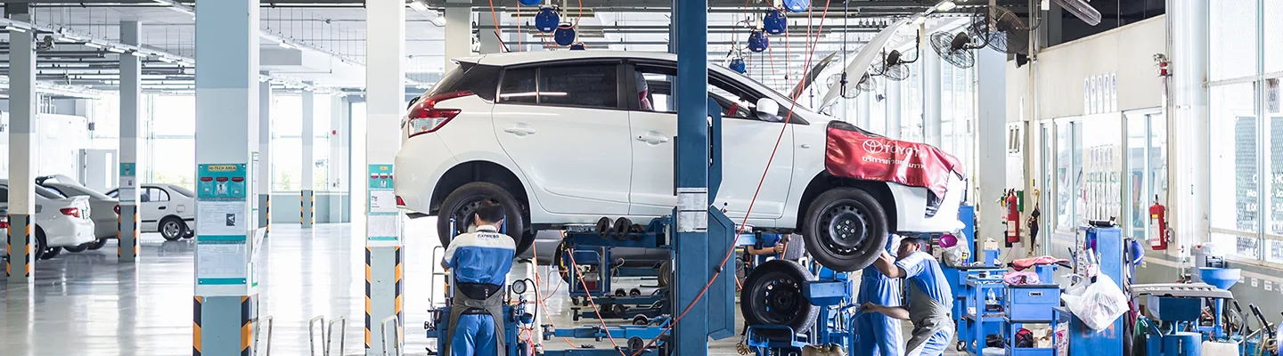 car up on lift in repair bay