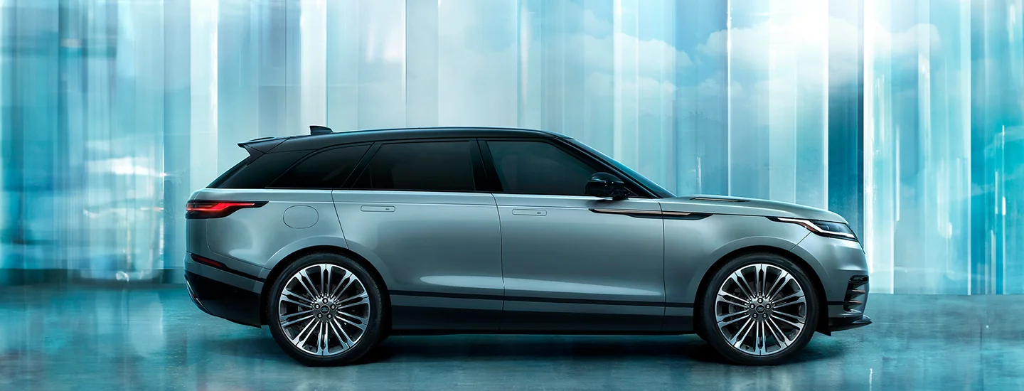 Side view of the 2026 Range Rover Velar parked in front of mirrors