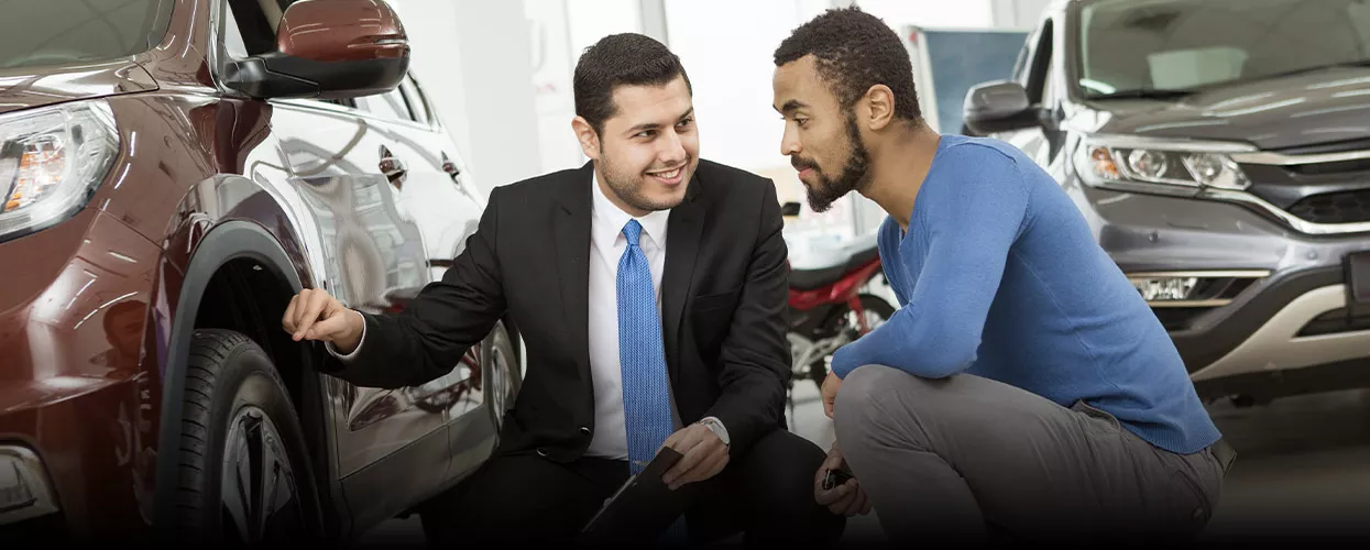 salesman showing man tires on a vehicle