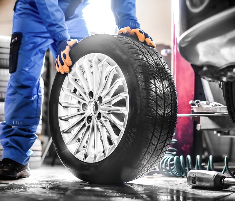 Service tech getting a new tire to change