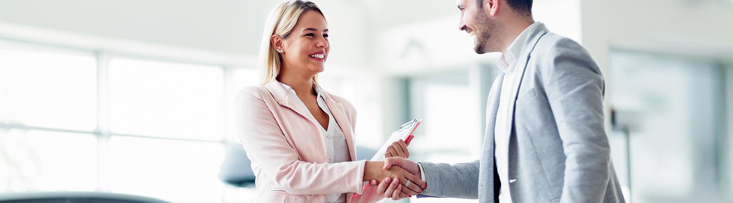 Saleswoman going over trade-in process with man