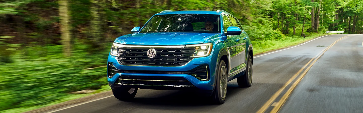 Volkswagen Atlas  blue color running  on road front view
