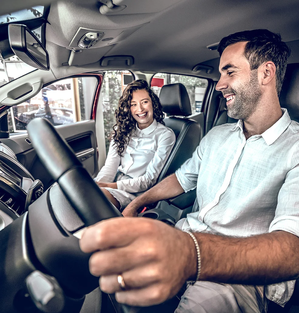 Two customer checking out the inside of a new Nissain