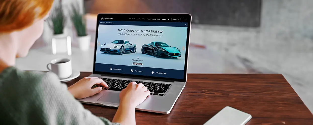 someone car shopping on laptop