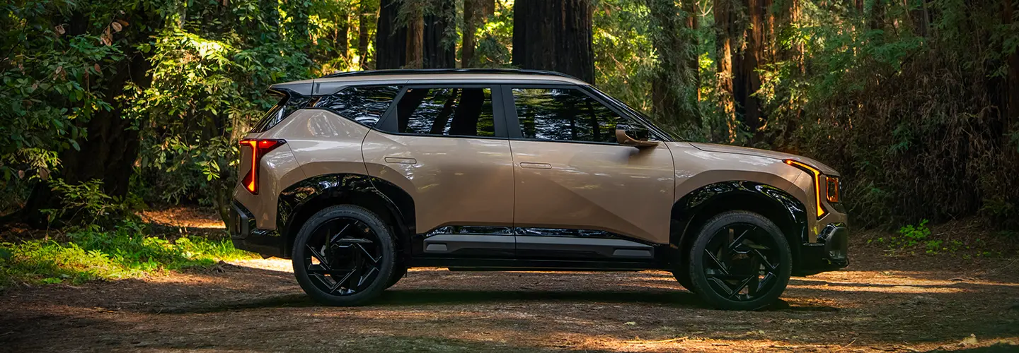 Gold 2027 Kia Seltos in the woods