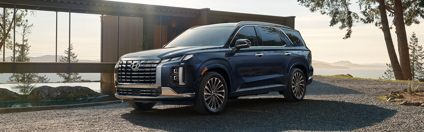 2025 Hyundai Palisade parked in front of a lake house
