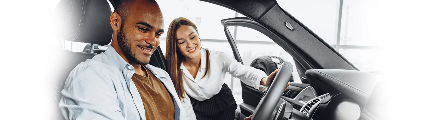 Car salesperson shows a Toyota Corolla Cross to a customer
