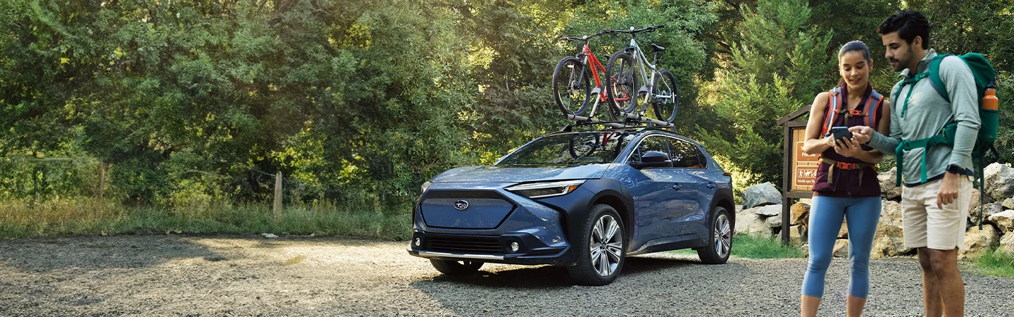 guys in the desert next to blue Subaru Solterra