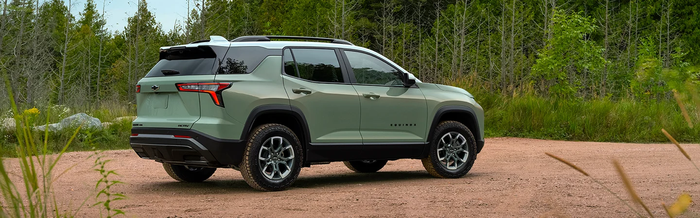 Chevy Equinox parked in front of a trailhead