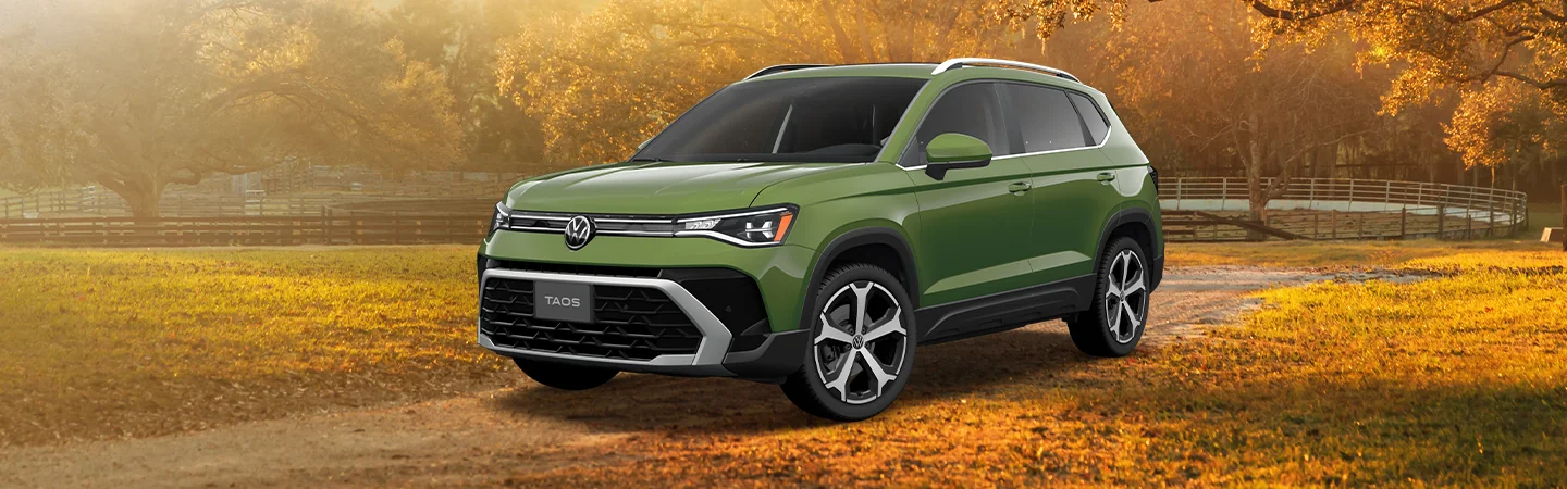 green 2025 Volkswagen Tiguan SEL R-Line parked on dirt road in fall