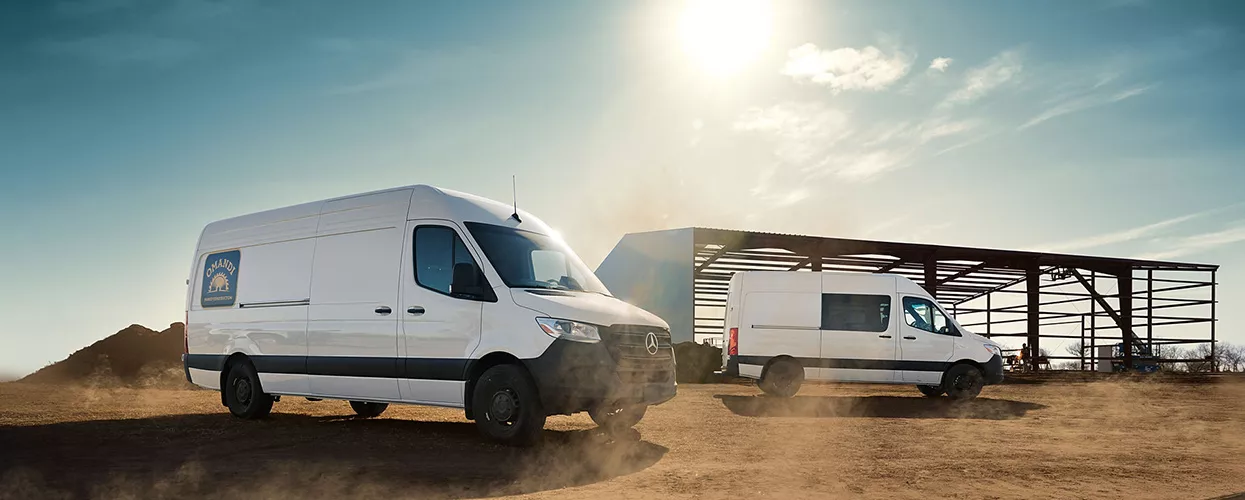 2 white Sprinters on dirt
