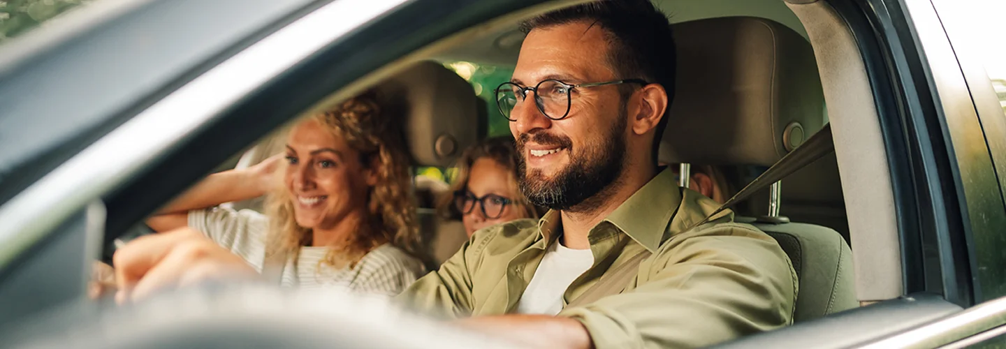couple smiling in driving off in a new Pre-Owned Jaguar