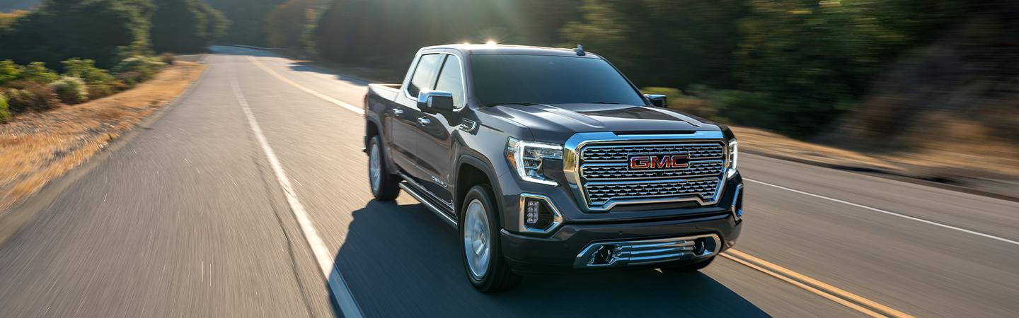 GREY 2021 GMC SIERRA DRIVING ON HIGHWAY