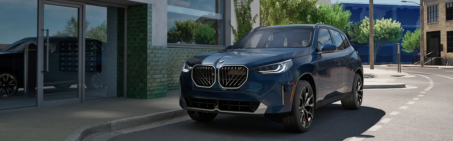blue 2025 BMW X3 driving in a city