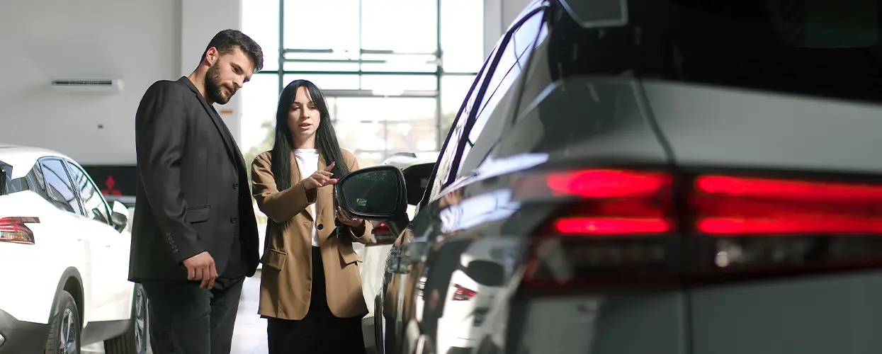 looking at new car in car showroom