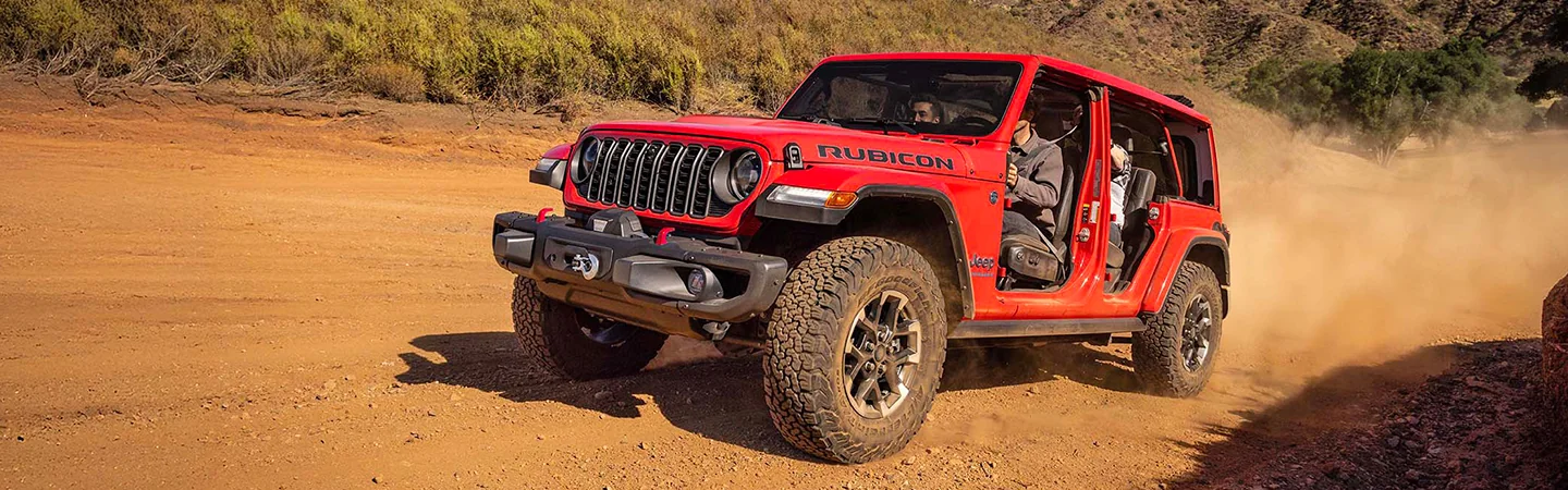 2025 Jeep Wrangler vs Ford Bronco Red Jeep om offroad view
