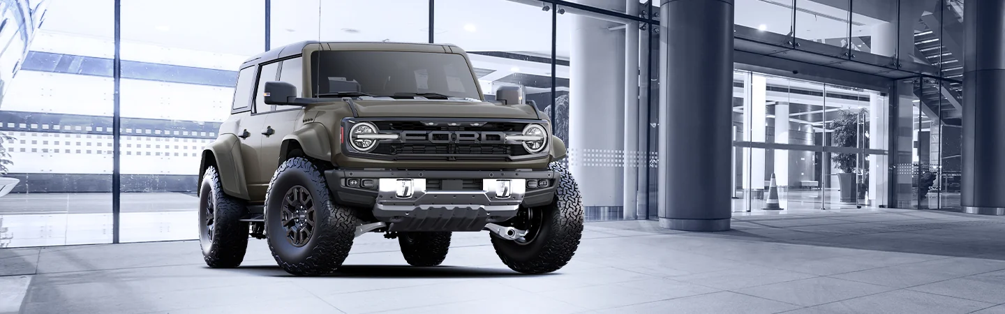 2025 Jeep Wrangler vs Ford Bronco dark green jeep standing on company area