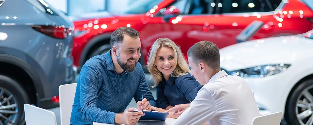 couple is car shopping in showroom