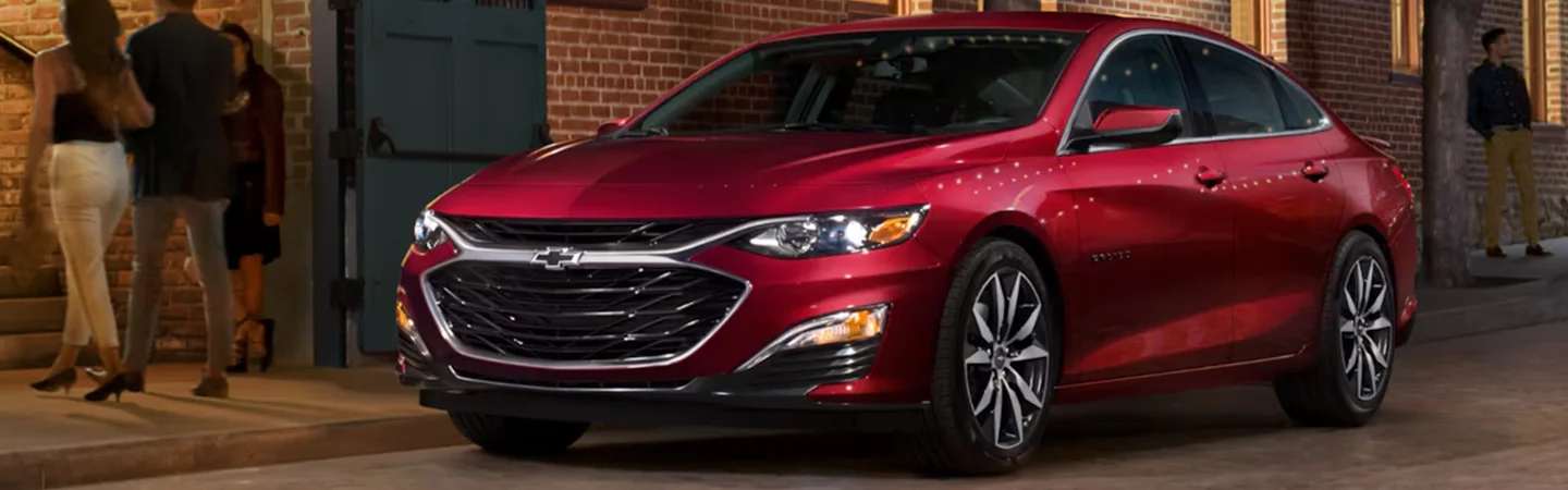 A red 2025 Chevrolet Malibu parked on a city street