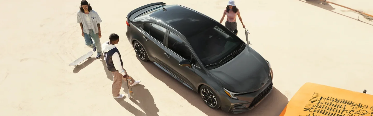 Top view of the top of a gray 2024 Toyota Corolla with people getting into it