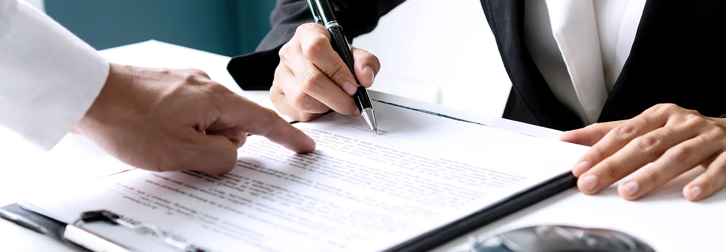 Sales person helping customer fill out paperwork