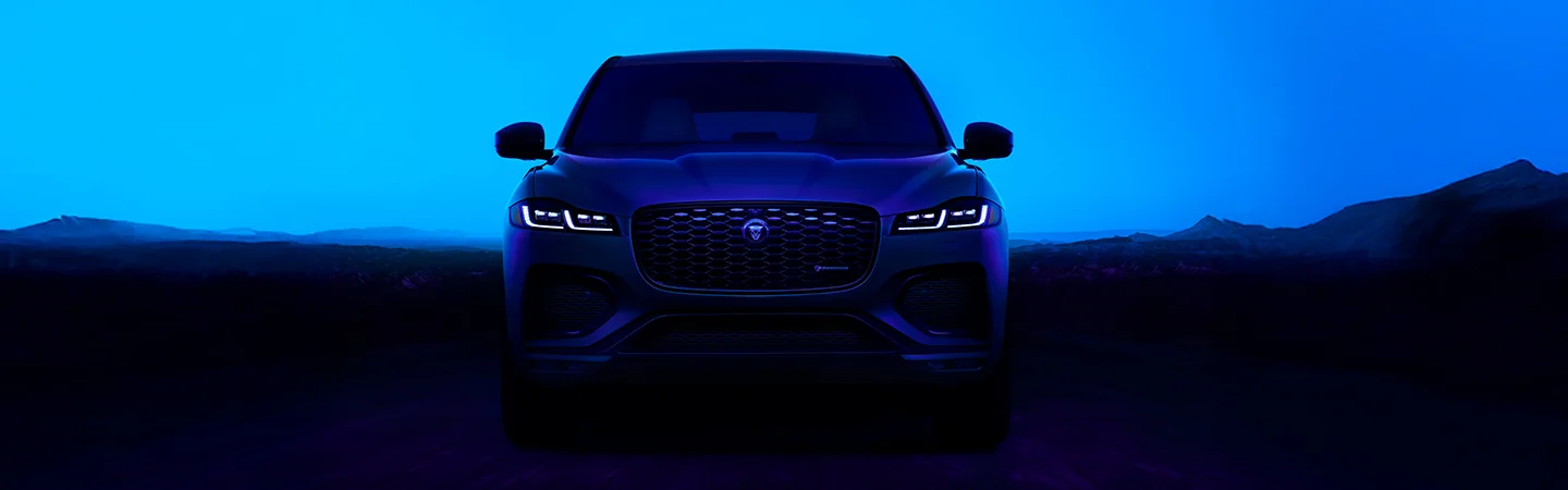 blue 2025 Jaguar F-PACE parked in mountains