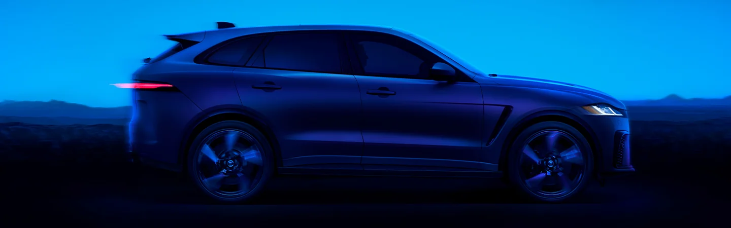 blue 2025 Jaguar F-PACE driving in mountains