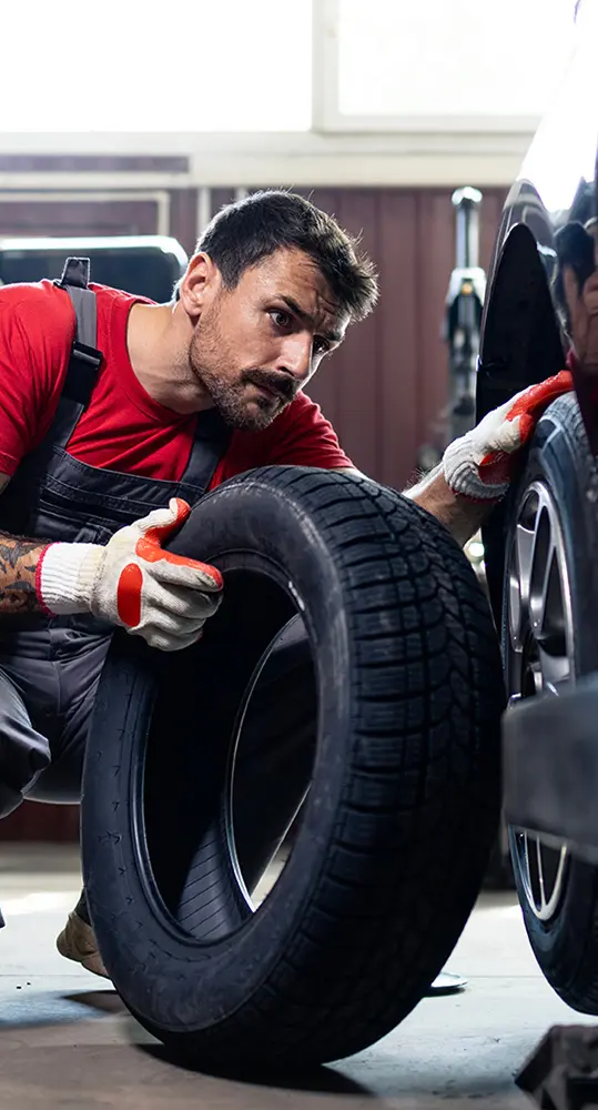 tech installing new tire in service bay in Tampa FL