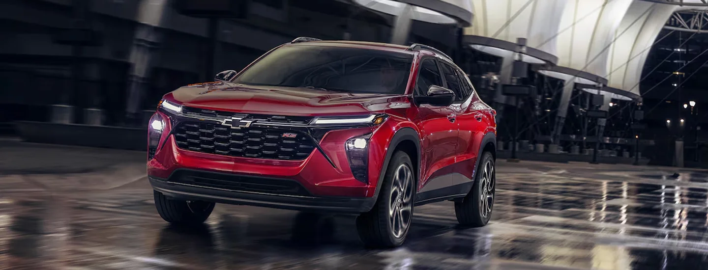 Red 2025 Chevrolet Trax driving in the city