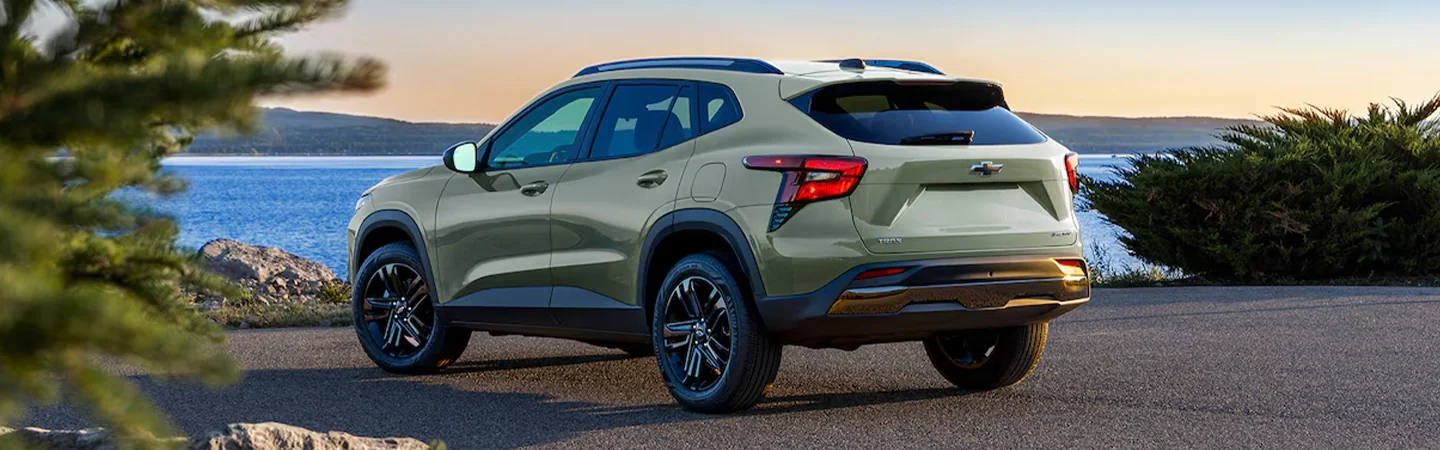Back side view of a parked 2025 Chevrolet Trax with water in the background