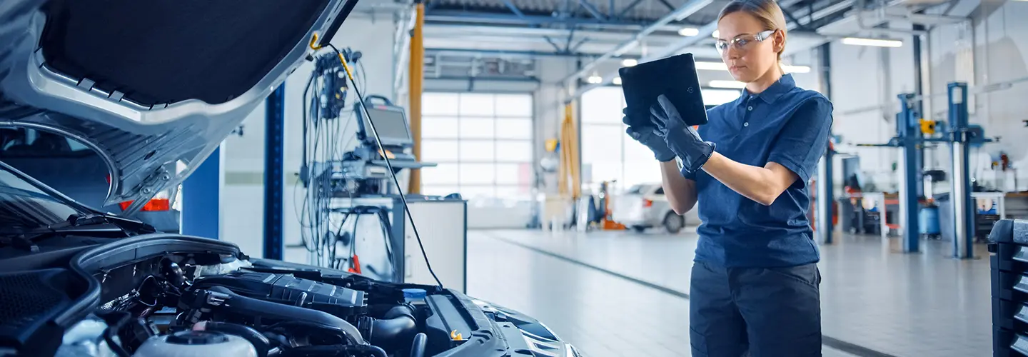tech working on car engine