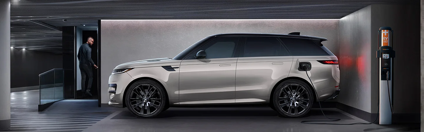 Side view of a parked 2025 Range Rover Hybrid charging