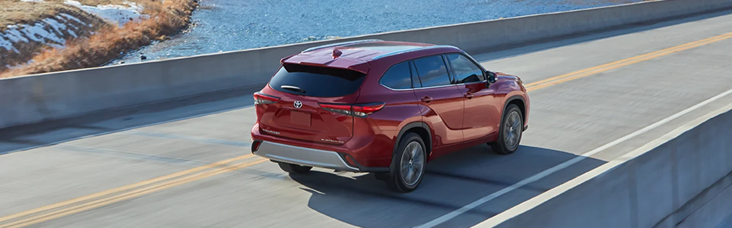 2025 Toyota Highlander Red color car on highway back View