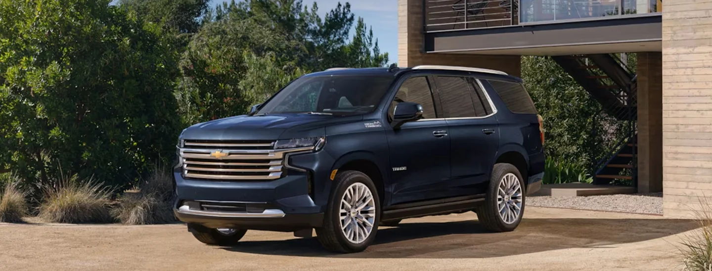A black parked 2024 Chevrolet Tahoe in a driveway