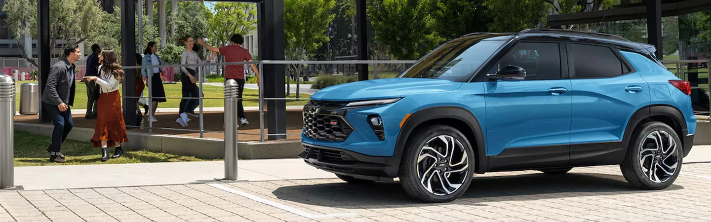 Side view of a parked blue 2025 Chevrolet Trailblazer at a park