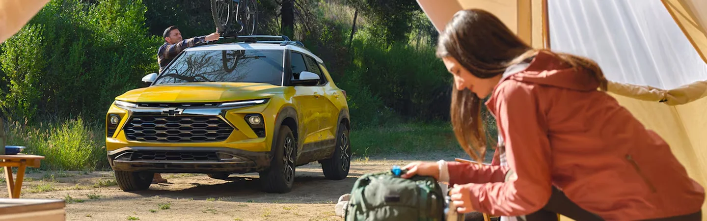 Front view of a parked yellow 2025 Chevrolet Trailblazer at a camp site