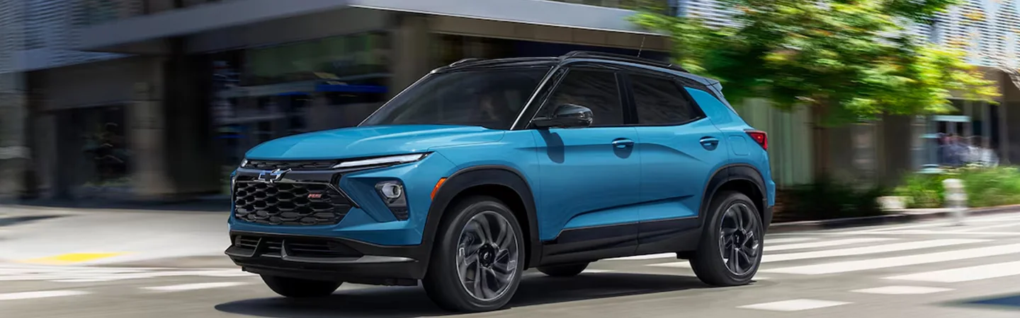 A blue 2025 Chevrolet Trailblazer driving in the city
