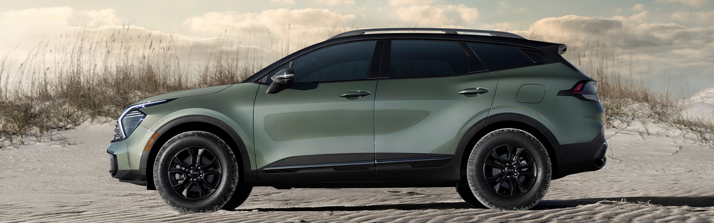 drivers side view on beach 2025 Kia Sportage