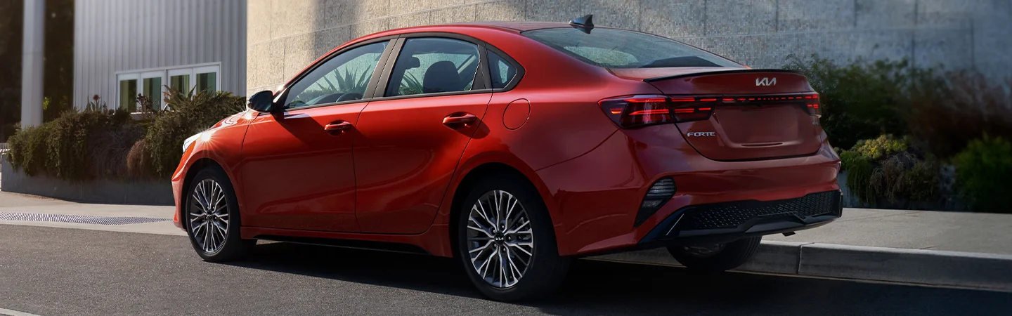 2024 Kia Forte vs Nissan Sentra side back in red 