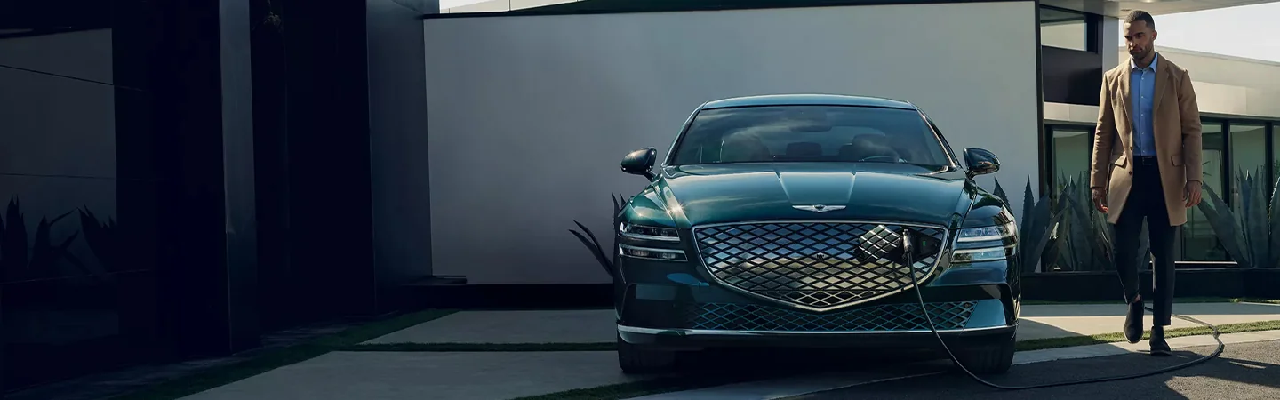 2024 Genesis Electrified G80 vs Tesla Model S lightgreen color front view 