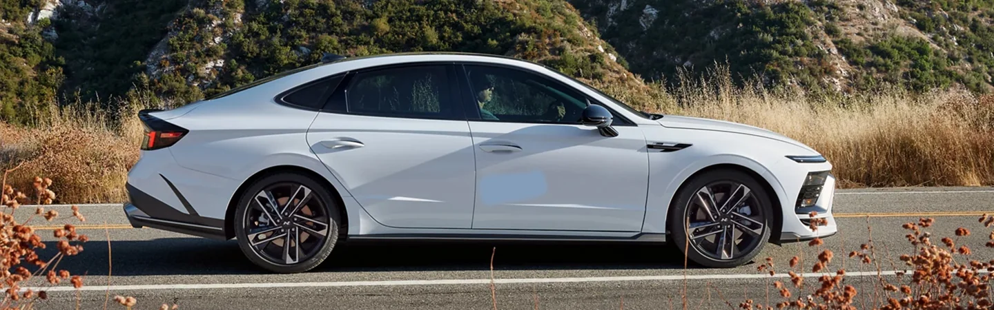 Hyundai Sonata Hybrid side view on dirt road